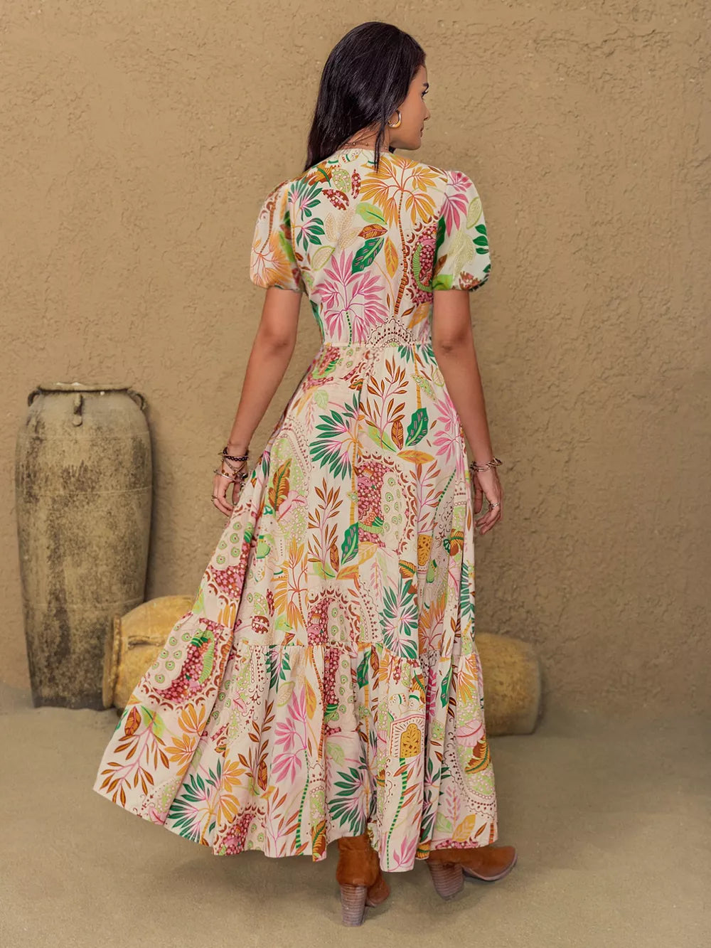 Maxi dress with tropical floral print, lace trim, puff sleeves, and tiered skirt.