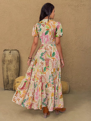 Maxi dress with tropical floral print, lace trim, puff sleeves, and tiered skirt.