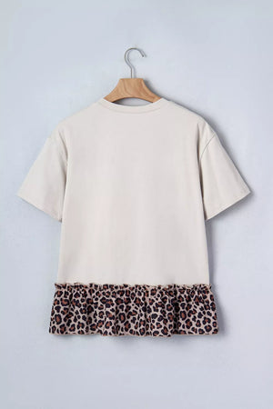 Cream cotton blend t-shirt with short sleeves and a ruffled leopard print hem.