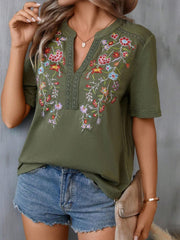 Army green V-neck tee with colorful floral embroidery and crochet trim detail.