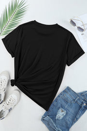 Black t-shirt with cuffed sleeves and a knotted hem, styled with denim shorts and sneakers.