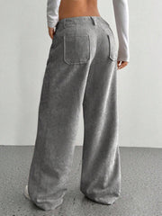 Gray corduroy wide-leg utility trousers with back patch pockets and a relaxed fit.