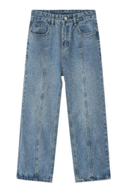 Medium wash denim jeans with vertical seam detail and straight leg cut.