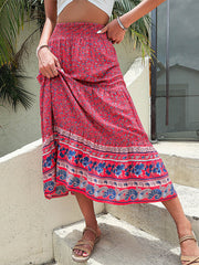 Bohemian tiered midi skirt in hot pink with a floral print and paisley border.