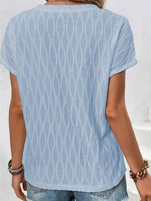 Light blue textured tee with short sleeves and a subtle wave pattern.