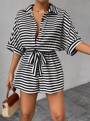 Black and white striped belted romper with collared button-front top and short sleeves.