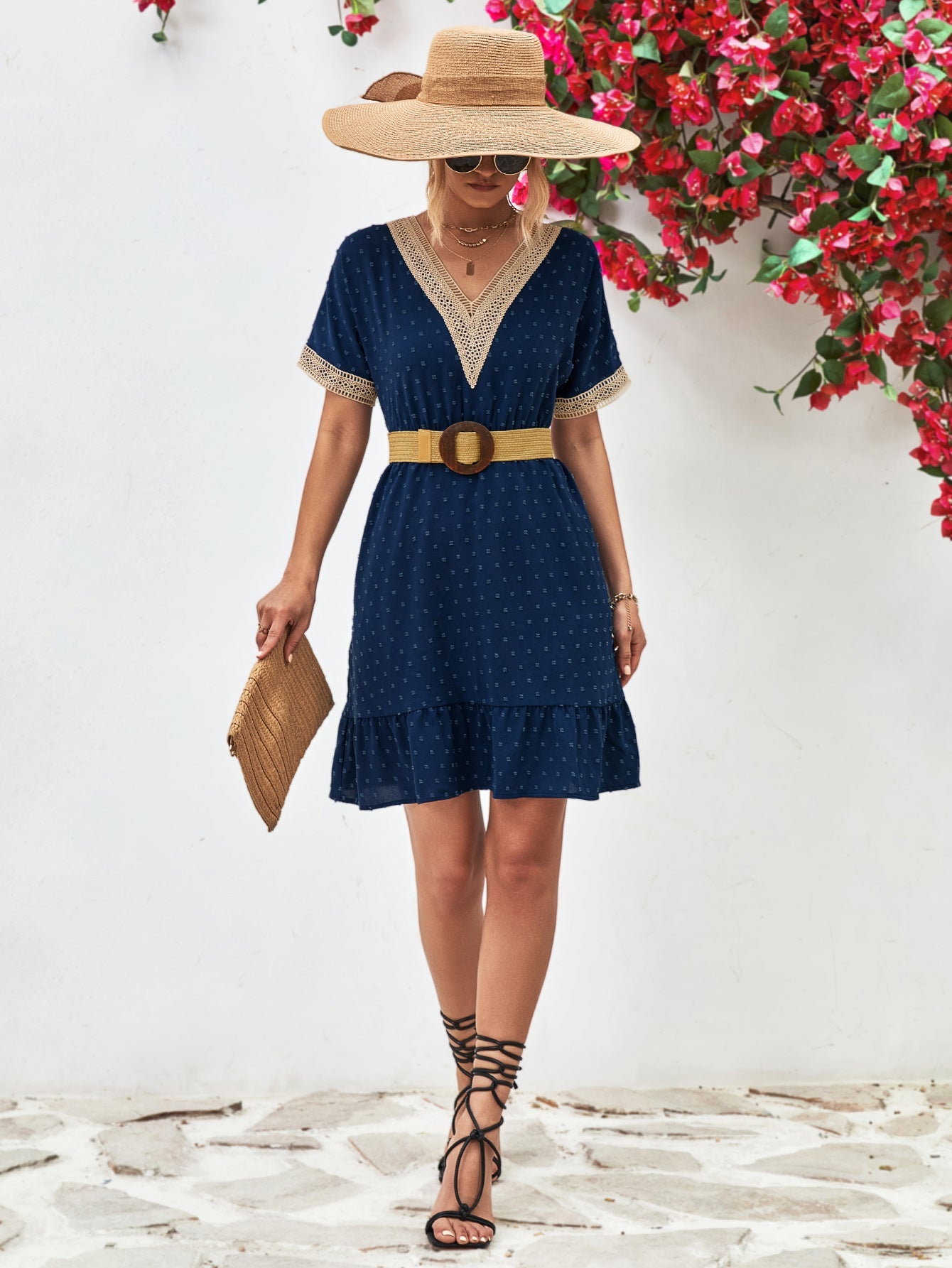 Dark blue Swiss dot dress with crochet trim V-neck and ruffled hem.