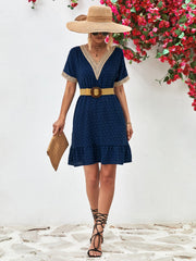 Dark blue Swiss dot dress with crochet trim V-neck and ruffled hem.