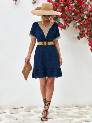 Dark blue Swiss dot dress with crochet trim V-neck and ruffled hem.