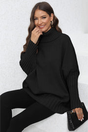 Black ribbed knit turtleneck sweater with batwing sleeves and wide cuffs.