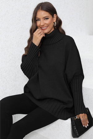 Black ribbed knit turtleneck sweater with batwing sleeves and wide cuffs.