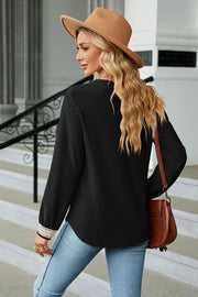 Black textured V-neck blouse with embroidered cuff detail