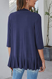 Navy blue cardigan with 3/4 sleeves and an asymmetrical ruffle hem.
