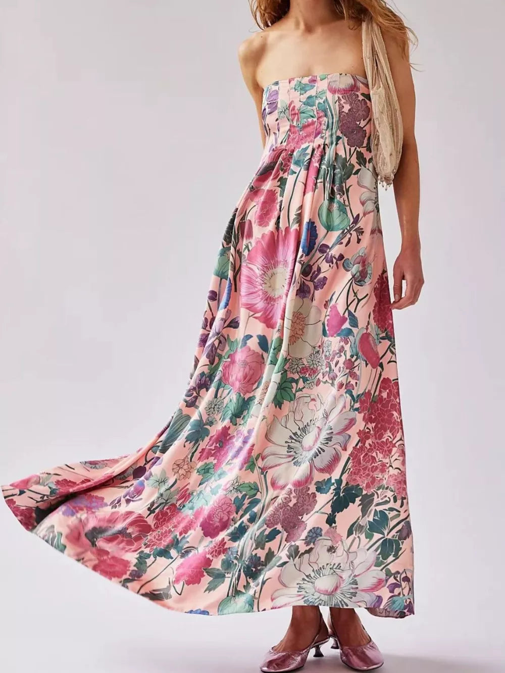 Vibrant floral maxi dress in pink with gathered bodice and flowing skirt.