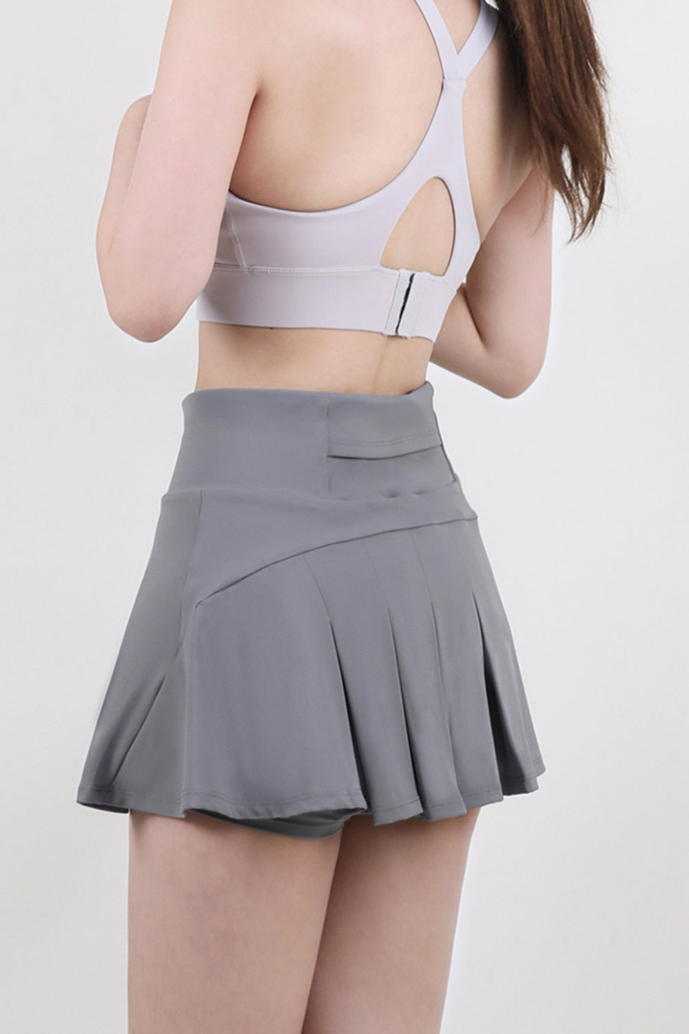 Dark Gray sculpted flared active skort with built-in shorts and pleated skirt detail.