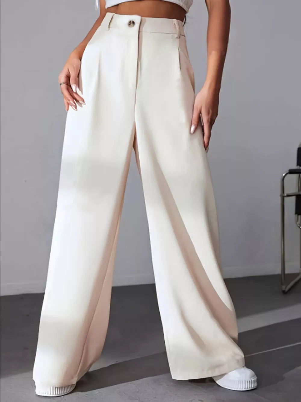 Apricot high-waisted pleated wide-leg maternity trousers with button closure.
