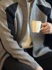 Gray ribbed zip-up track jacket with black contrast panels and a stand-up collar.