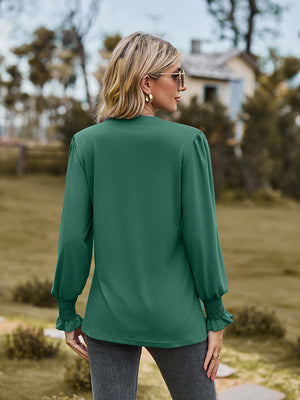 Green long sleeve blouse with pleated yoke and shirred cuffs