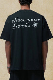 Black graphic t-shirt with white "chase your dreams" text and star graphic on back.