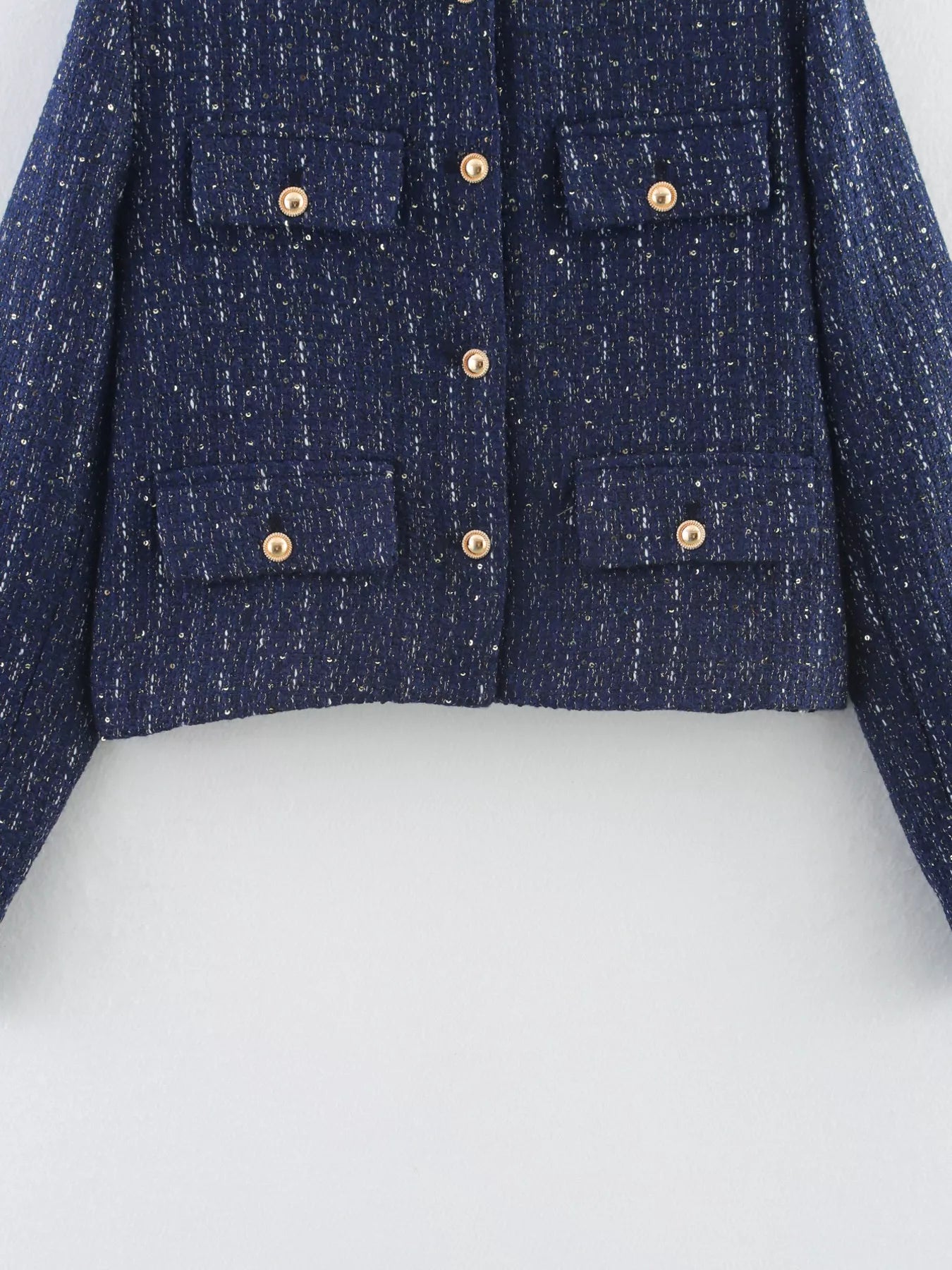 Dark blue cropped tweed button-up jacket with gold buttons and chest pockets.
