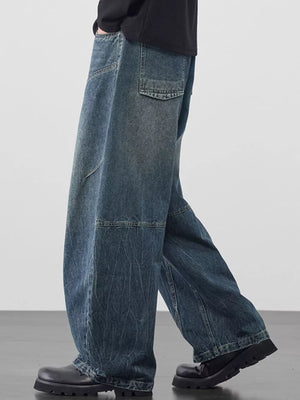 Refined wide-leg jeans in Vintage Blue denim with geometric paneling and distressed detailing.