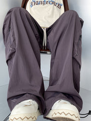 Men's mauve cargo sweatpants with drawstring and zippered pockets.