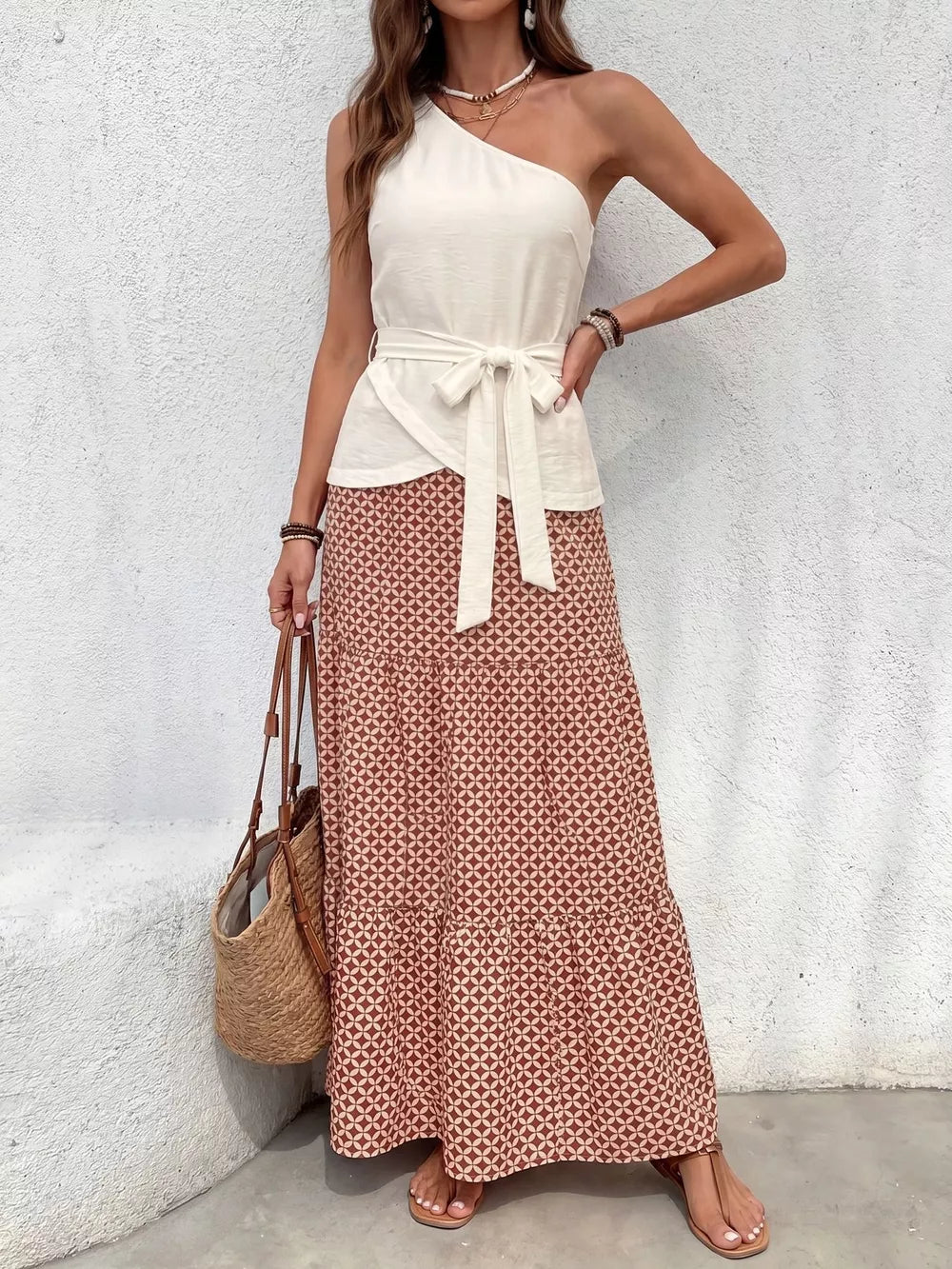 Cream one-shoulder top with tie waist and geometric print maxi skirt set