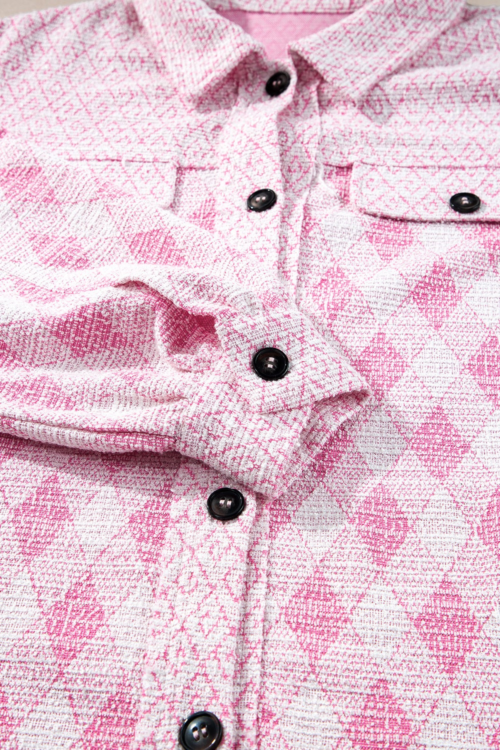 Pink diamond weave shacket with puff sleeves and buttoned front.