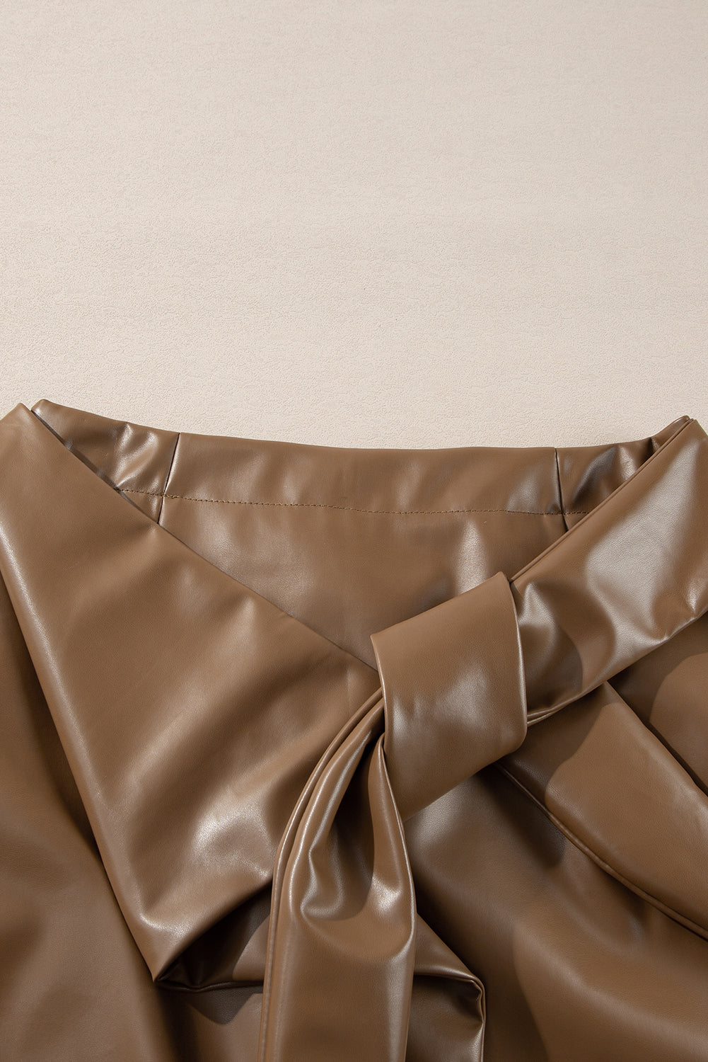 Brown faux leather mini skirt with knot-front detail