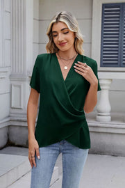 Dark green short sleeve blouse with draped front and V-neck.