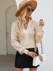 Tan houndstooth cropped cardigan with pearl buttons and V-neck.