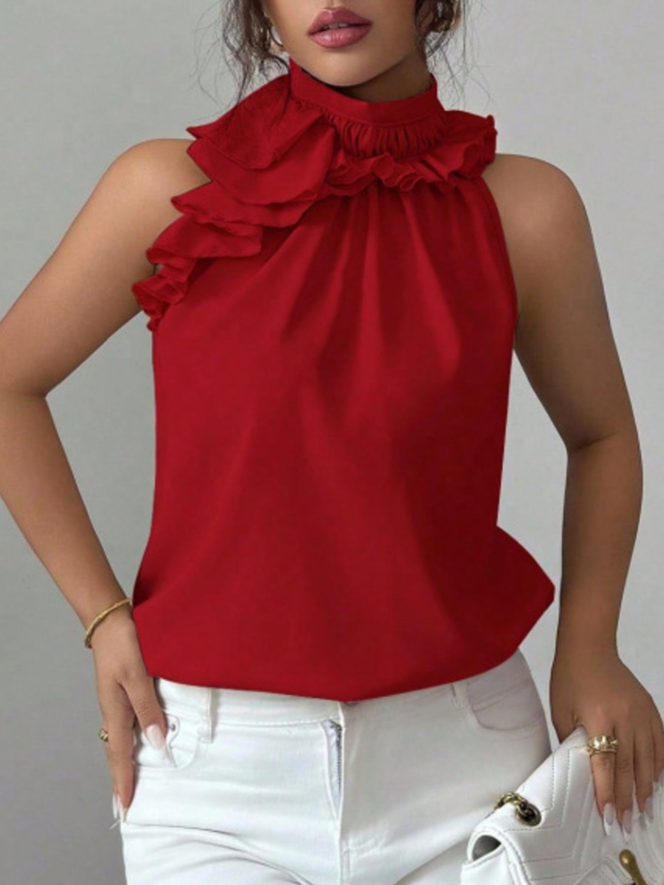 Ruffled high neck sleeveless top in red, black, apricot, or brown.