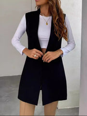 Black draped lapel vest with asymmetric hemline, worn open over a white top.