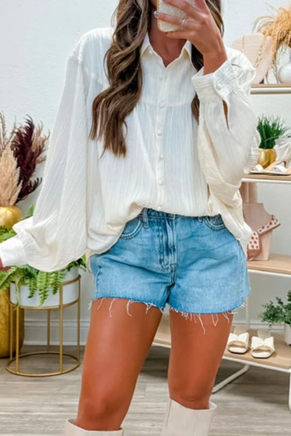 White crinkled texture shirt with button-down front and lantern sleeves.
