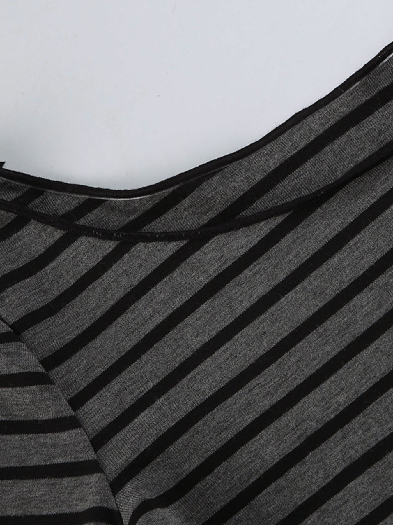 Gray and black striped t-shirt with boat neck and stretchy knit fabric.