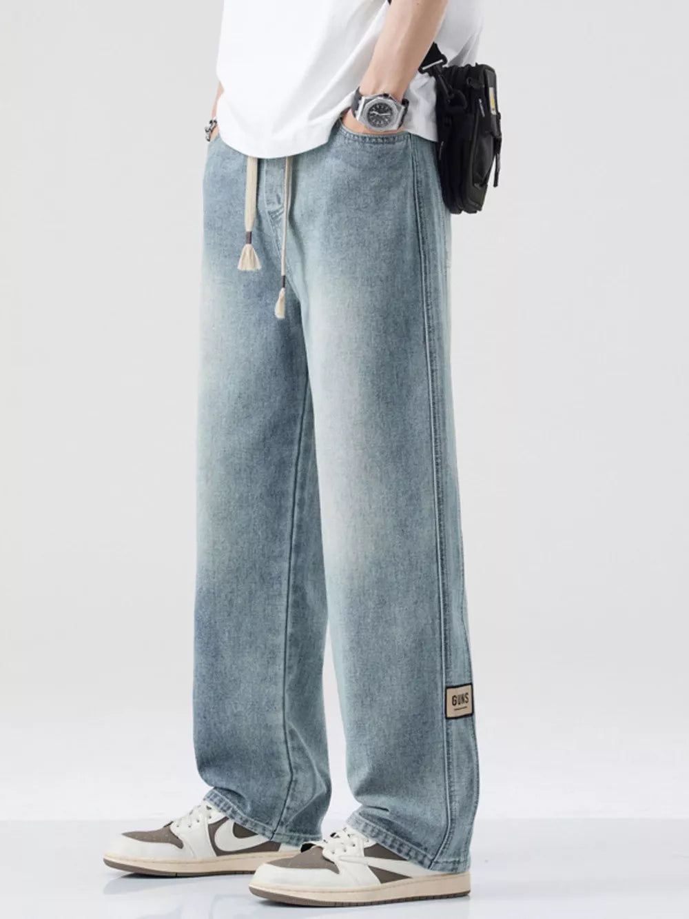 Premium oversized wide-leg men's jeans in Nostalgic blue cotton with drawstring and patch detail.