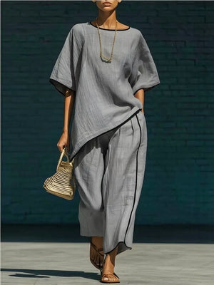 Gray two-piece set with contrast trim, half sleeves, and wide-leg pants.