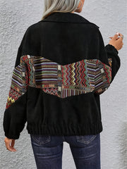 Black corduroy bomber jacket with colorful geometric patchwork detail on back and sleeves.