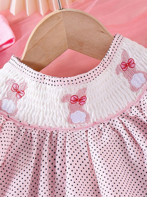 Pink polka dot baby dress with smocked white bodice and embroidered bunnies.