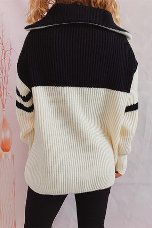 Ribbed knit quarter-zip sweater in black and white with striped sleeves.