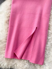 Pink knit midi skirt with a side slit detail.
