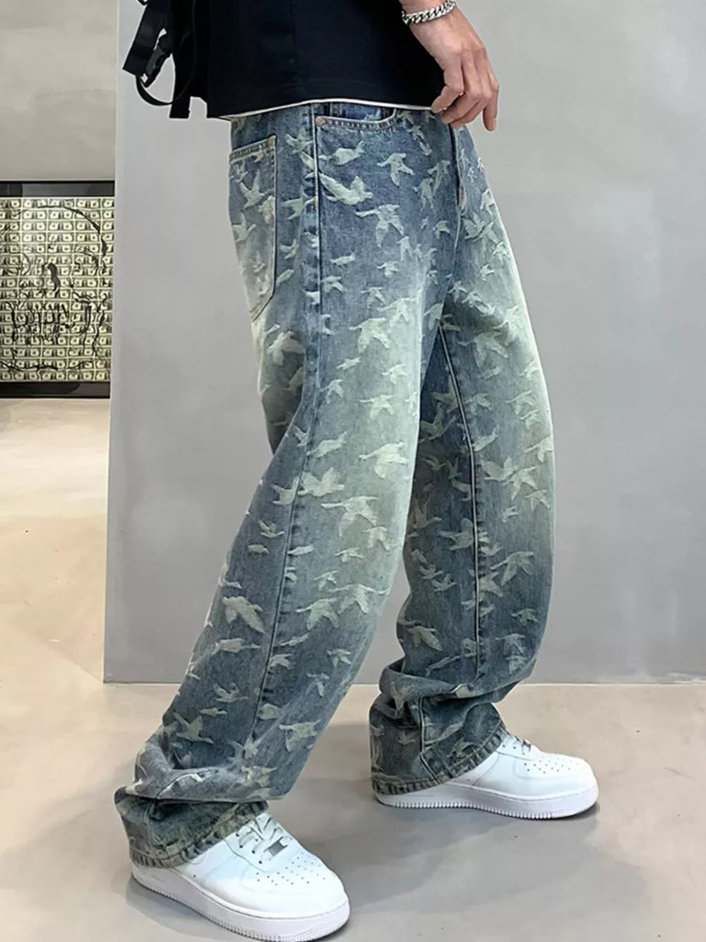 Loose-fit denim jeans with all-over bird print in vintage wash.