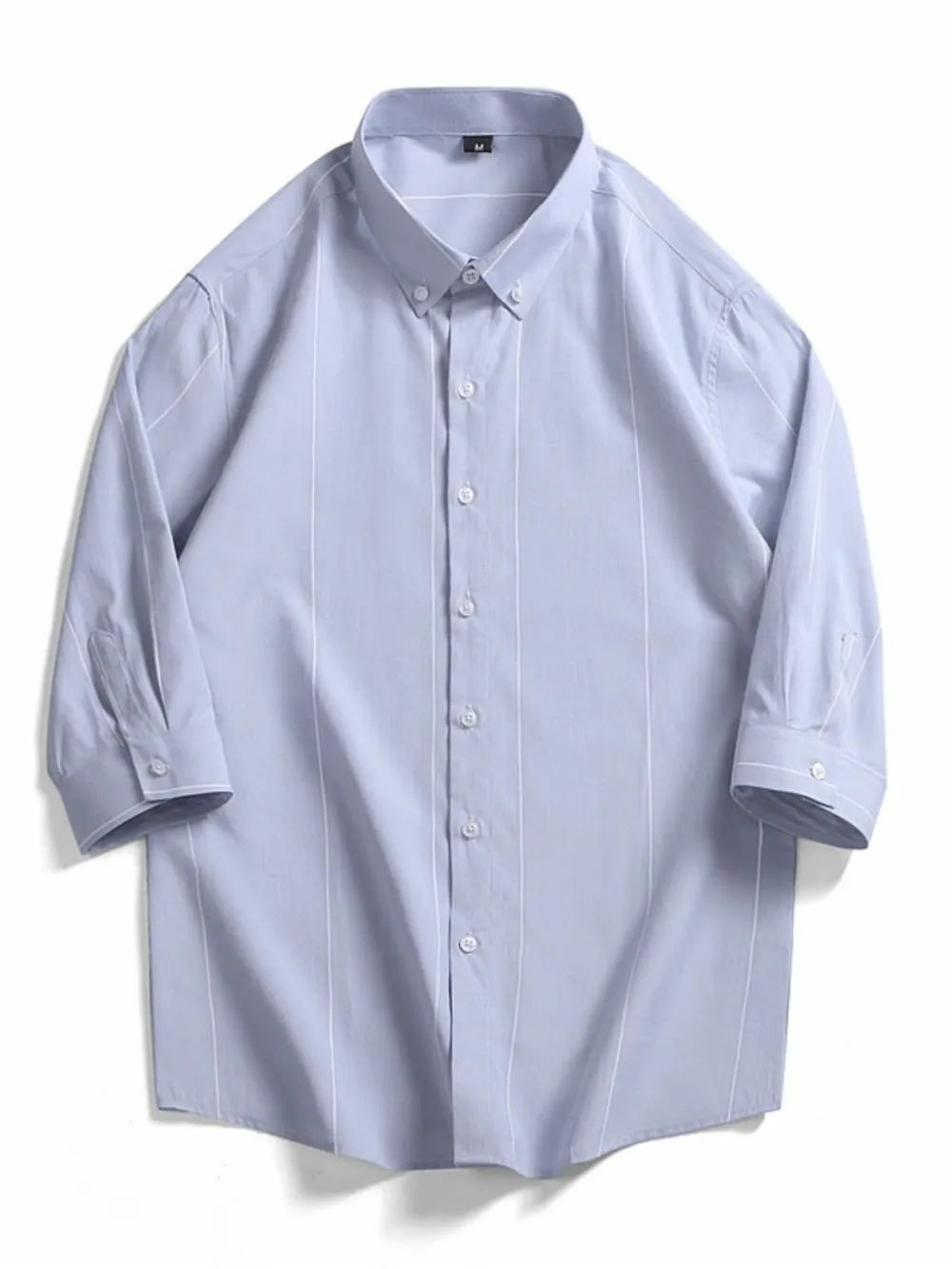 Light blue cotton oversized button-down shirt with white vertical stripes and buttoned cuffs.