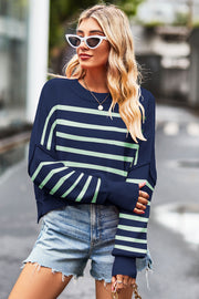 Dark blue knit crewneck sweater with light green stripes, boxy fit, and crew neckline.