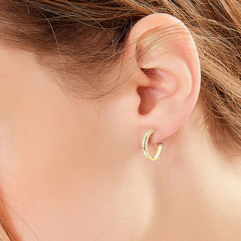 Gold pavé moissanite C-hoops in sterling silver with a D color grade.