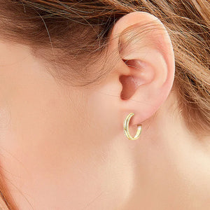 Gold pavé moissanite C-hoops in sterling silver with a D color grade.