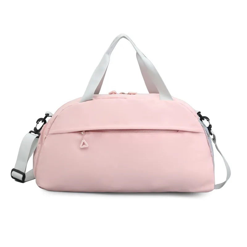 Blush pink duffel bag with detachable strap and front zip pocket.
