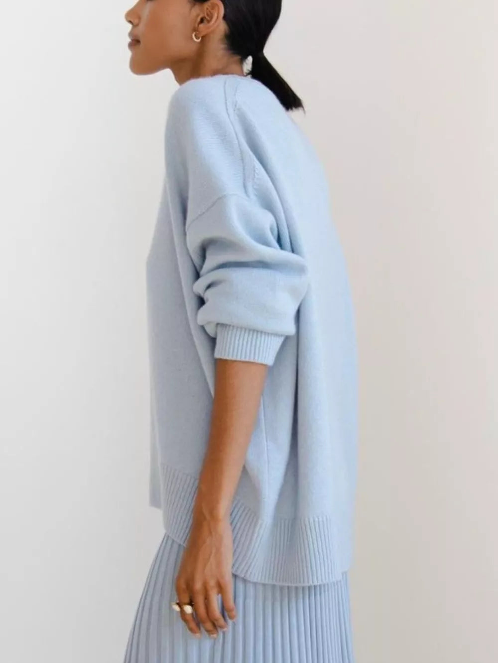 Light blue soft knit sweater with ribbed detailing and crew neckline.