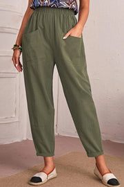 Relaxed linen tapered trousers in matcha green with pockets and elastic waist.