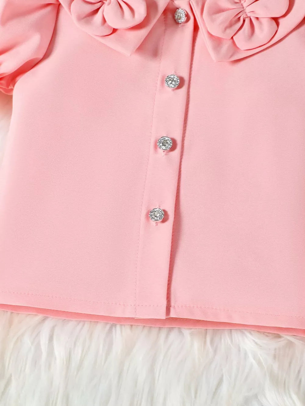 Pink toddler top with ruffle collar and jeweled buttons